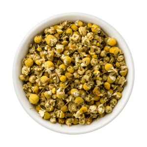 A white bowl full of beautiful, golden dried chamomile flowers.