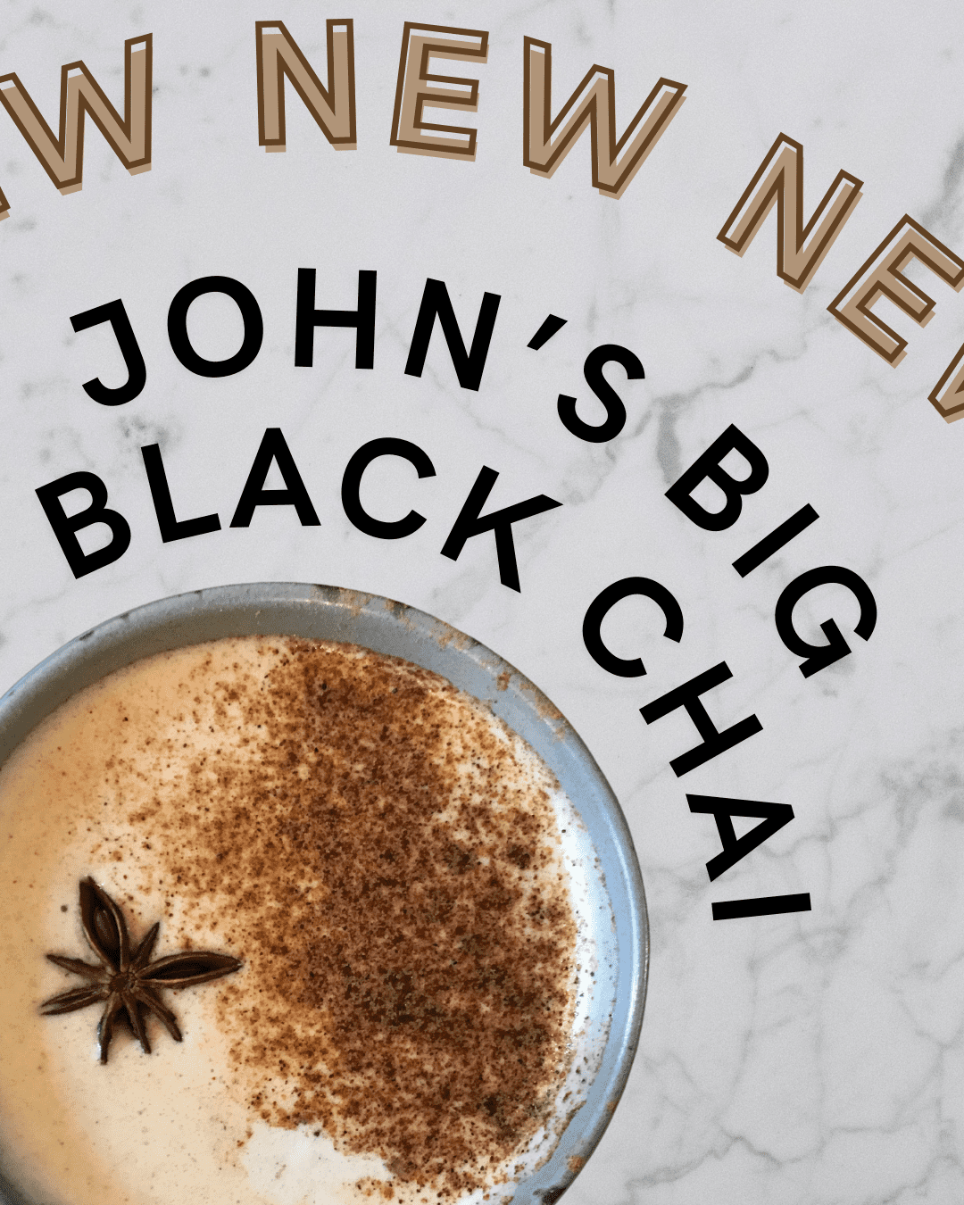 A large mug of creamy, bold, spiced chai latte, made with John's big black chai and topped with a sprinkle of cinnamon, allspice, and a star anise pod.